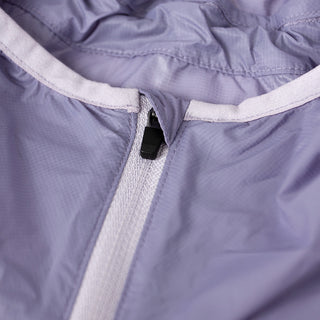 closeup view of the zipper of the ciele athletics VNTJacket lightweight running jacket for women in grape color